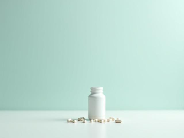 A bottle of magnesium glycinate capsules with a subtle, calming background